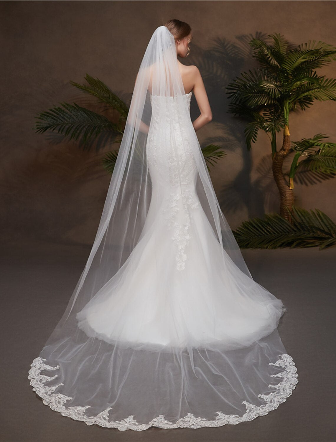 Close-up of lace appliques on a one-tier tulle wedding veil.
