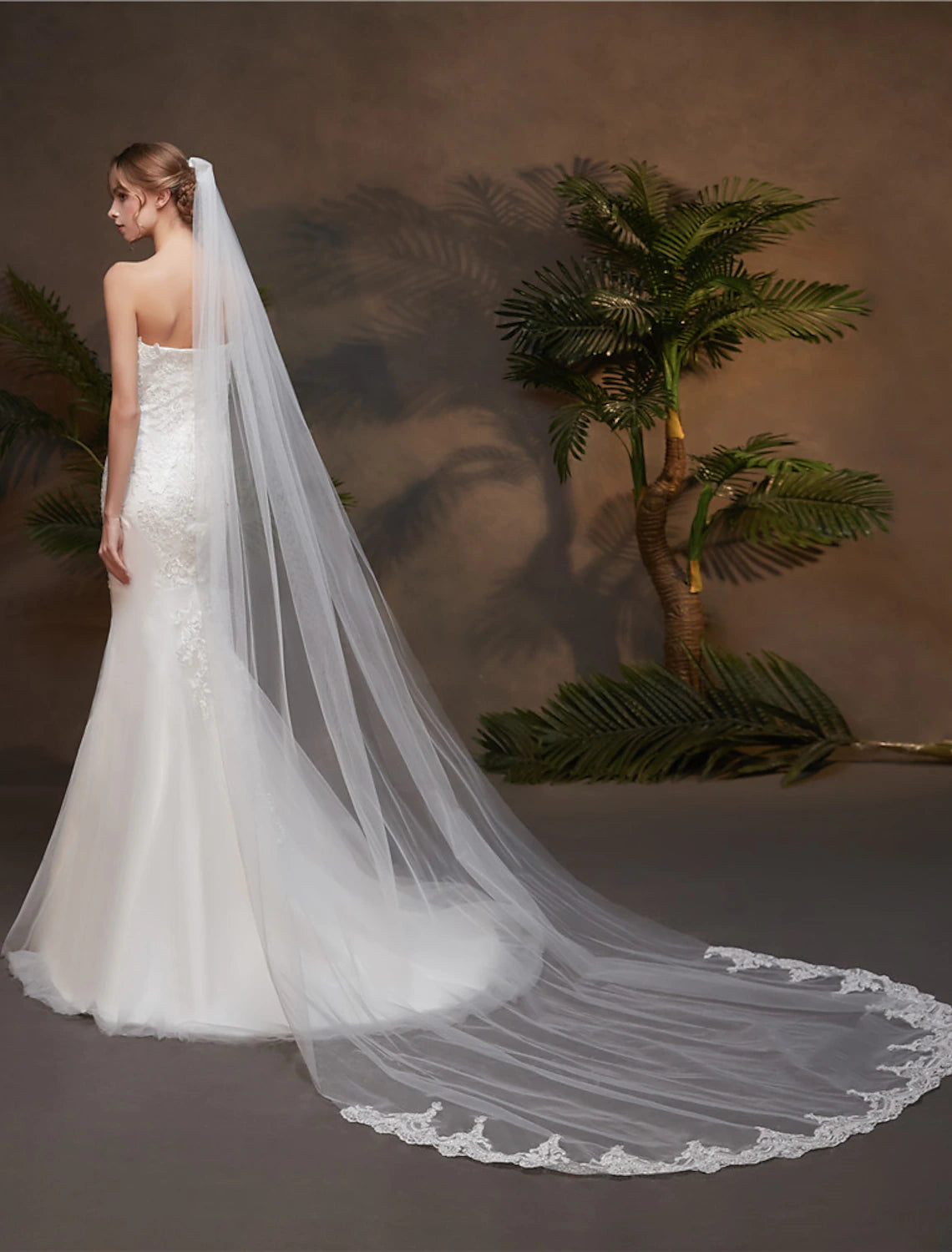 Back view of a bride with a flowing one-tier chapel veil.
