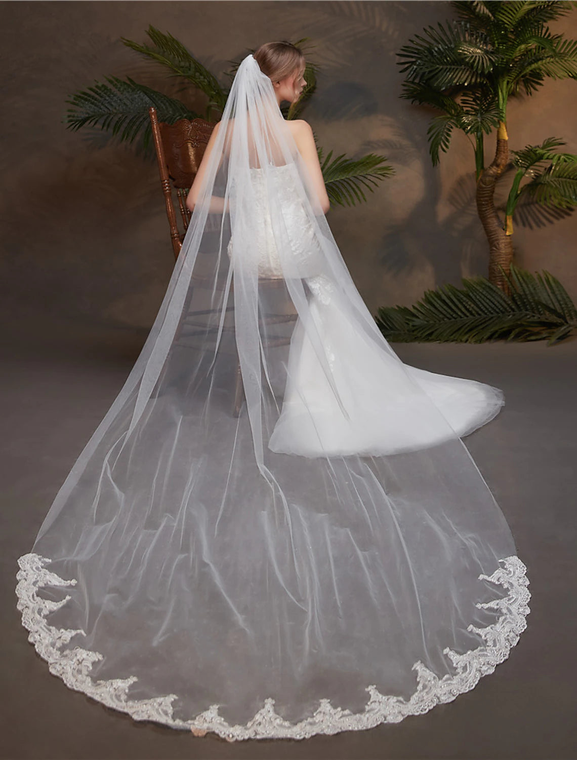 Detailed view of the lace edge on a bridal tulle veil.