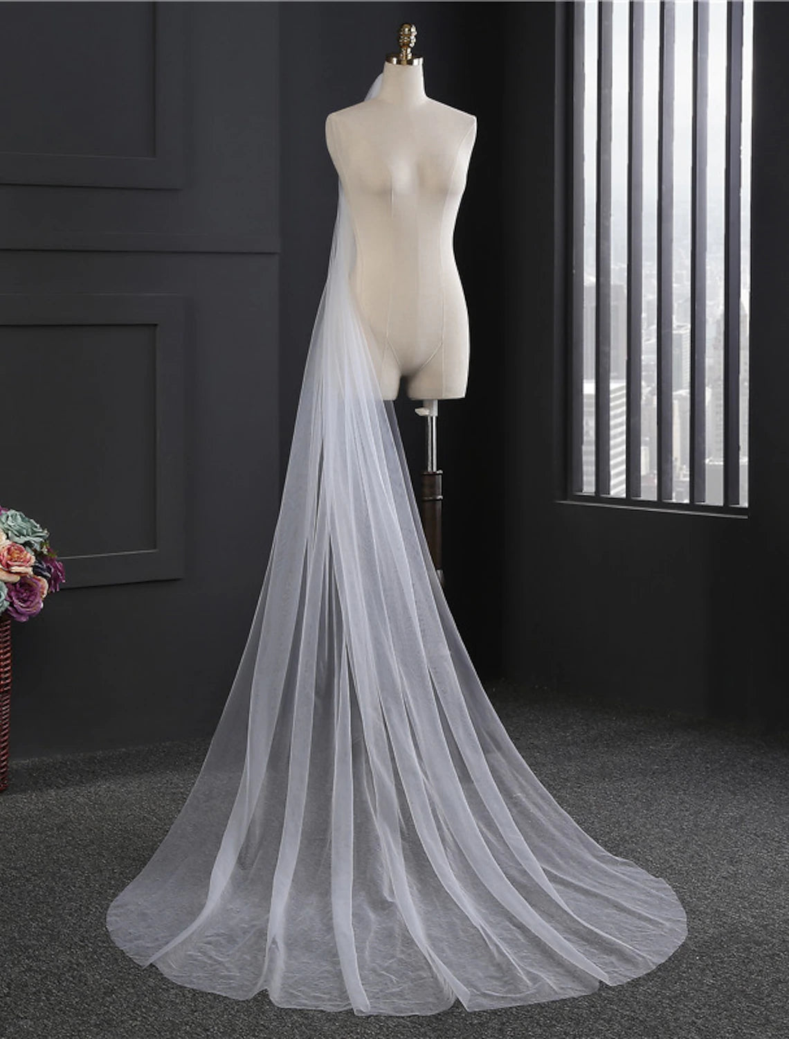 Back view of a bride wearing a flowing one-tier chapel veil.