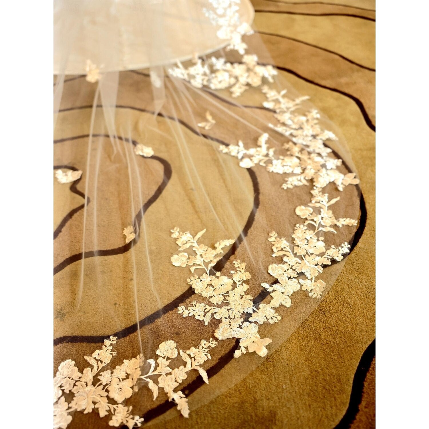 One-tier embroidered tulle wedding veil, chapel length.