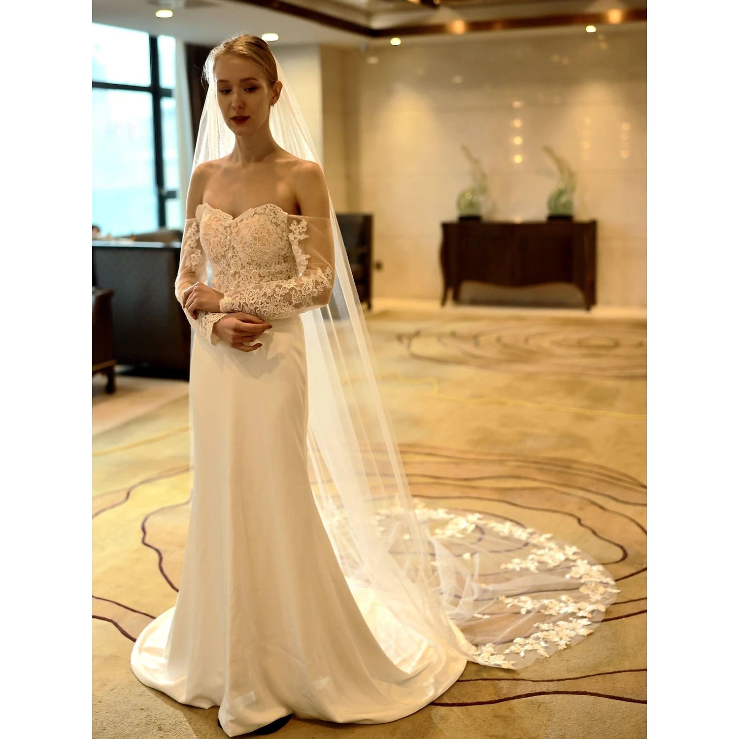 Wedding veil with intricate lace-like embroidery.