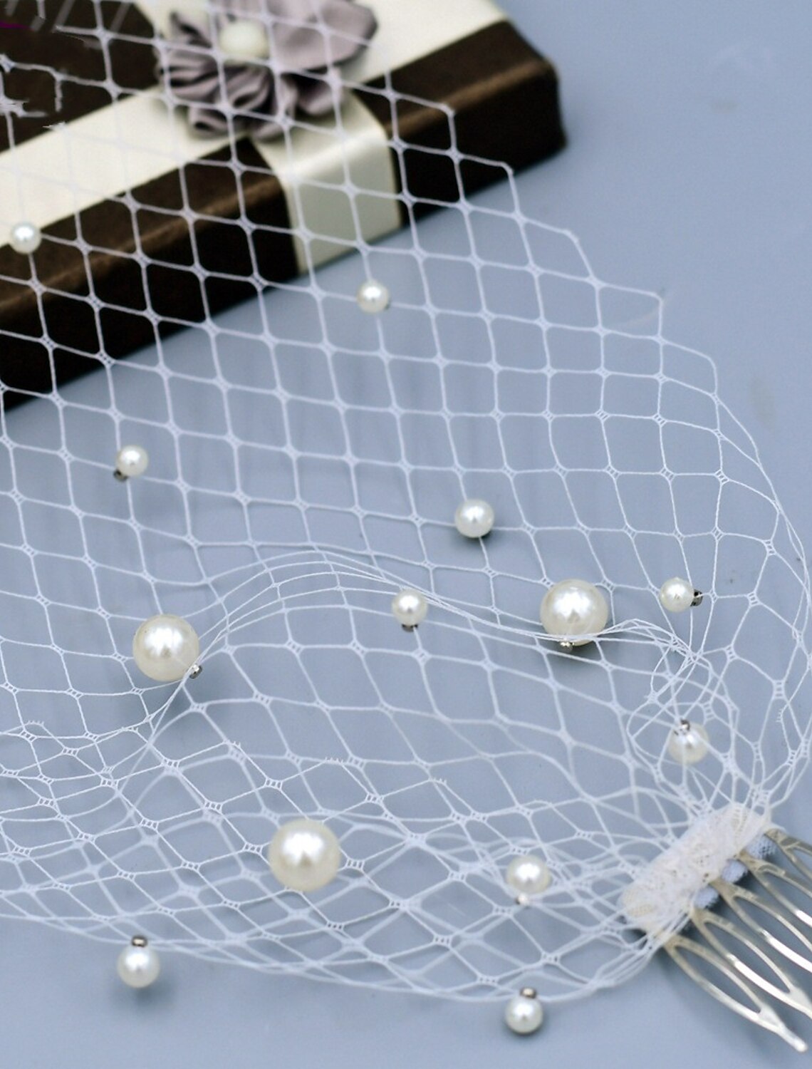 Bride wearing a one-tier European style wedding veil with faux pearls.