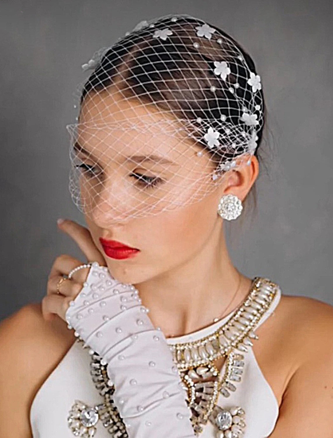 Bride wearing a one-tier wedding veil with faux pearls and petal tulle.