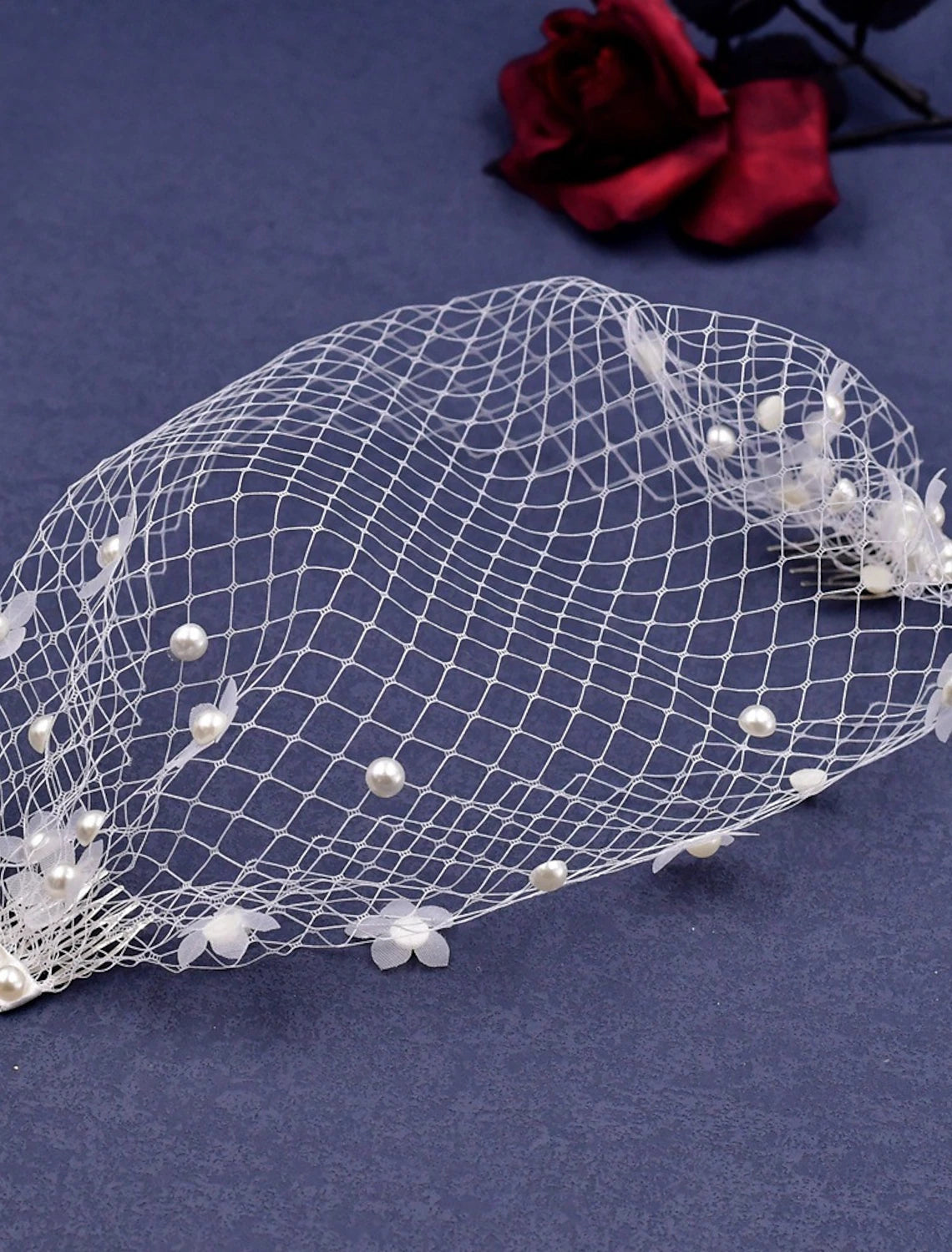 Close-up of a one-tier bridal veil featuring delicate faux pearls.