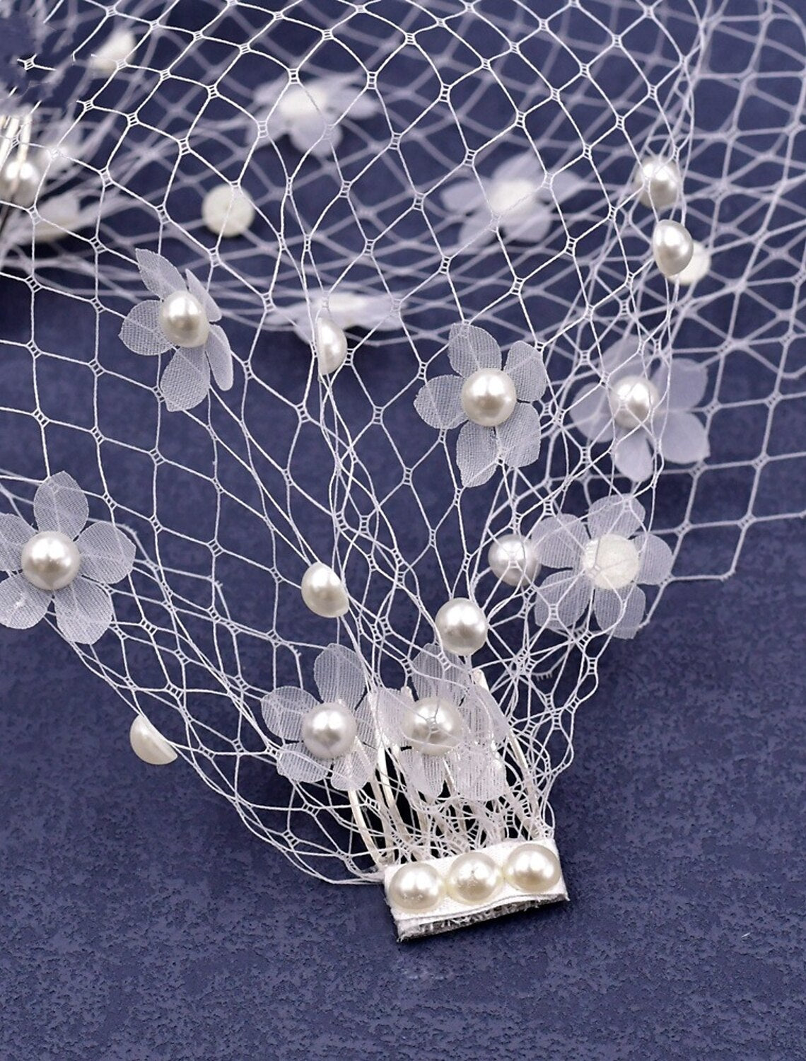 Elegant blusher wedding veil with petal tulle details on a bride.