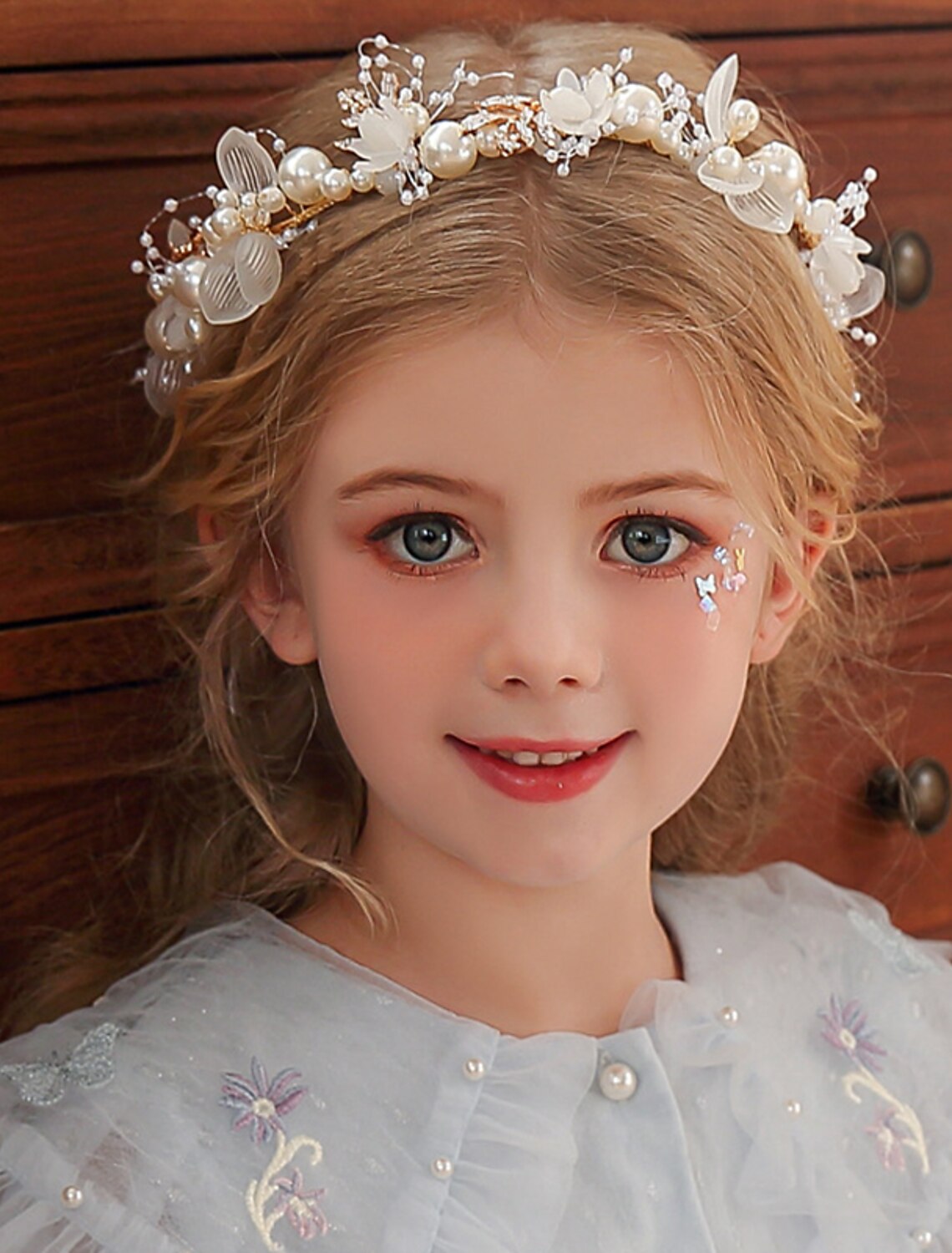 Elegant pearl and rhinestone tiara headband with intricate floral design.