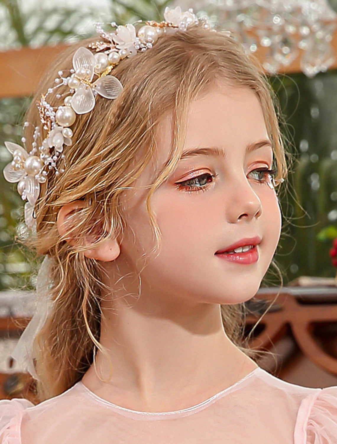 Close-up of a pearl and rhinestone tiara headband showcasing crystal details.