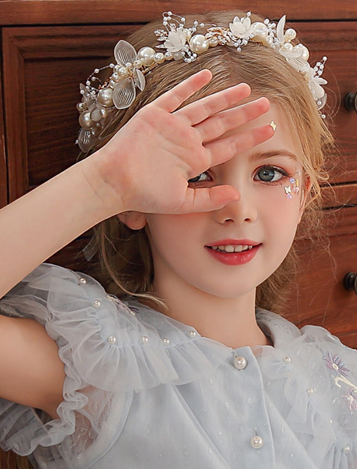 Detailed shot of the faux pearls and crystals on the tiara headband.