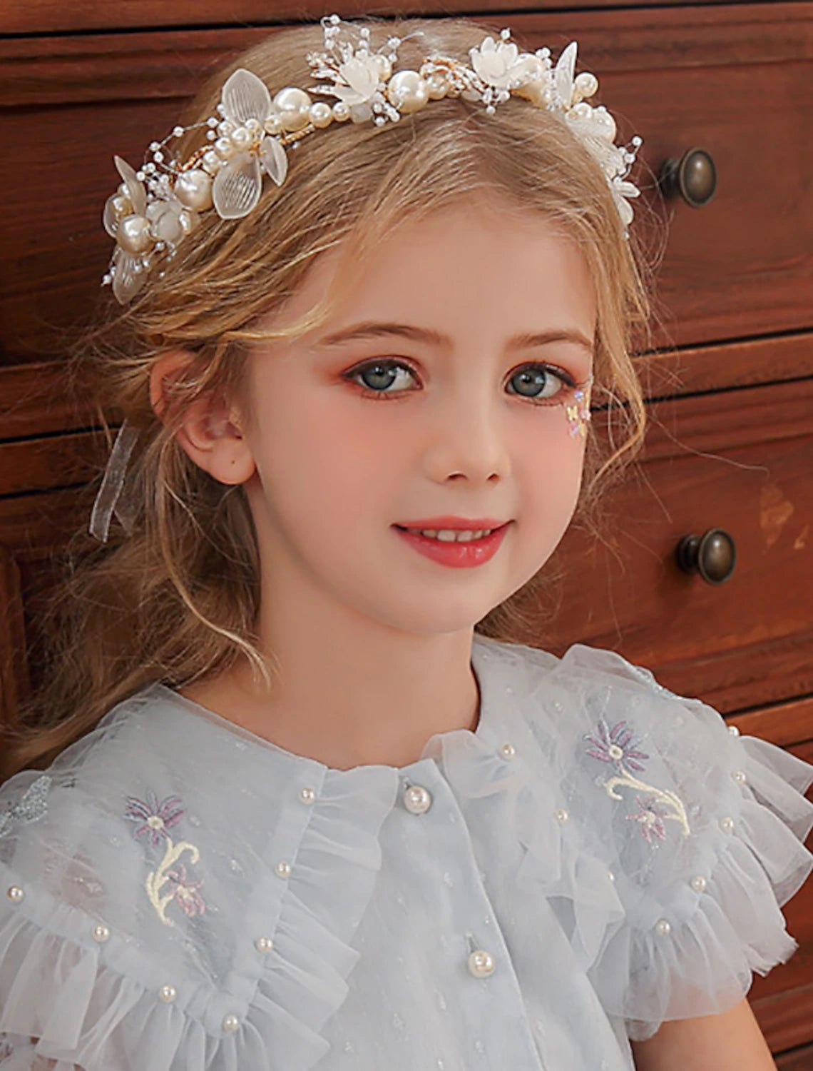 Back view of the pearl and rhinestone tiara headband showing its structure.