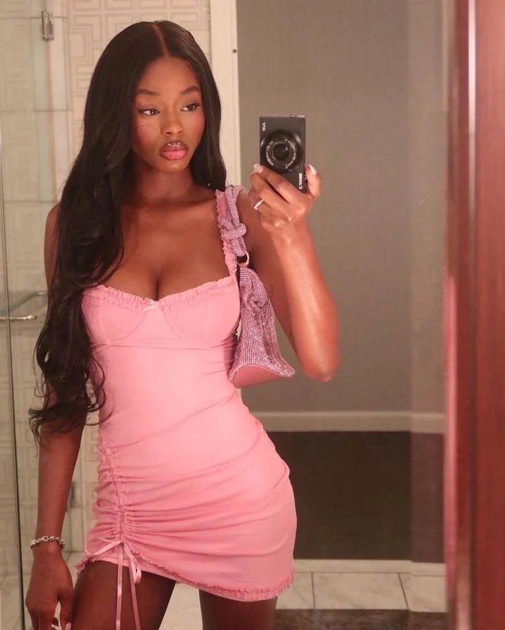 Pink ruched sweetheart homecoming dress with lace trim and drawstring hem.