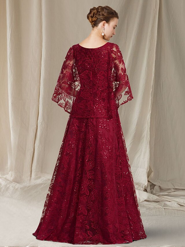 Full view of a plus size A-line mother of the bride dress, featuring floor length and sequin details.