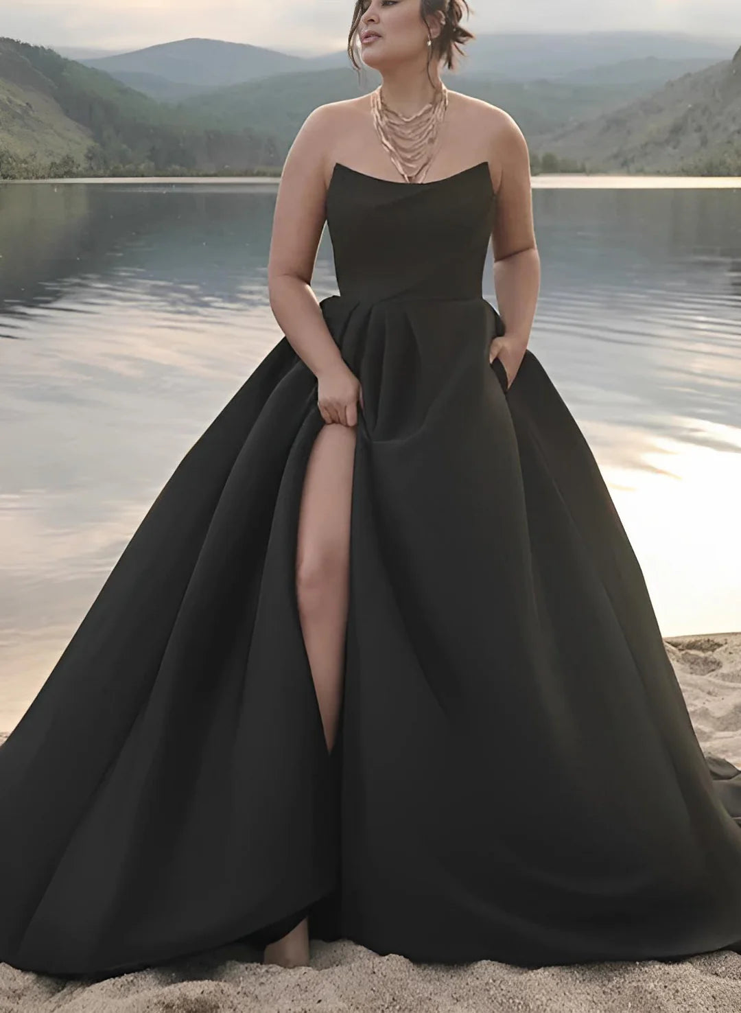 Back view of a plus size model wearing a white strapless A-line wedding dress.