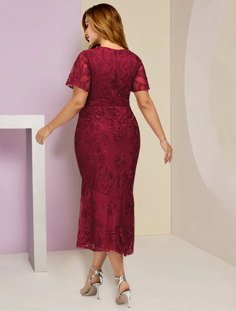 Back view of a plus size V-neck tea-length lace dress with short sleeves and pleats, showcasing the elegant design.