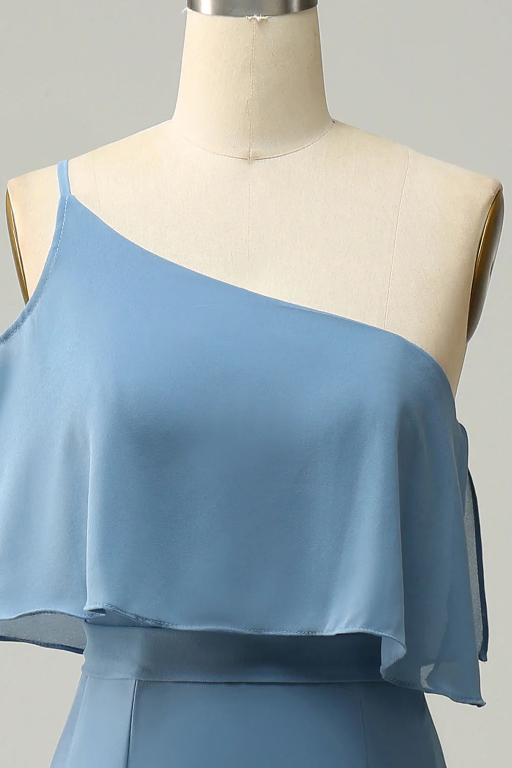 Close-up of the one shoulder neckline detail on a plus size sheath dress.