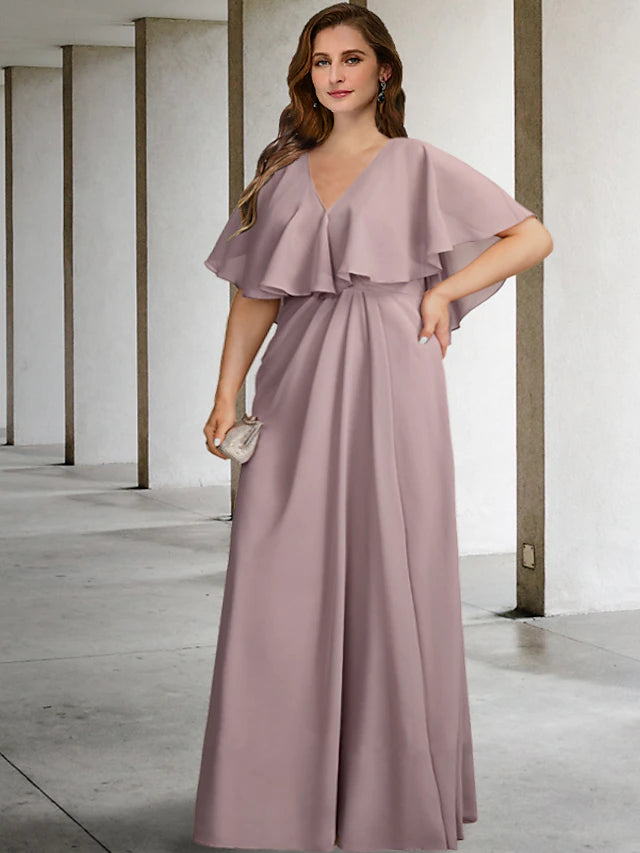 Woman wearing a two-piece A-line V-neck chiffon plus size mother of the bride dress.