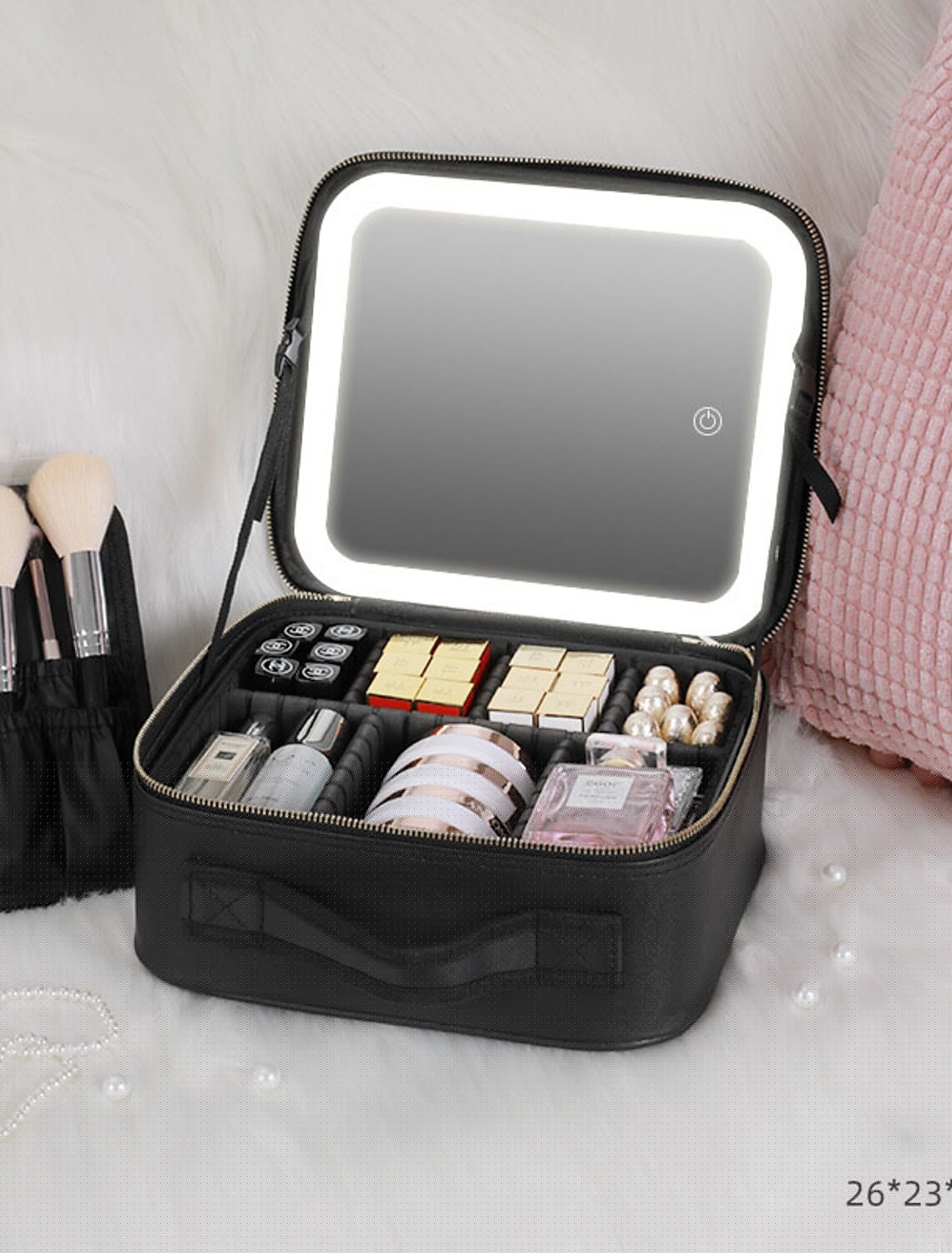 Makeup bag interior with various cosmetics organized by adjustable dividers.