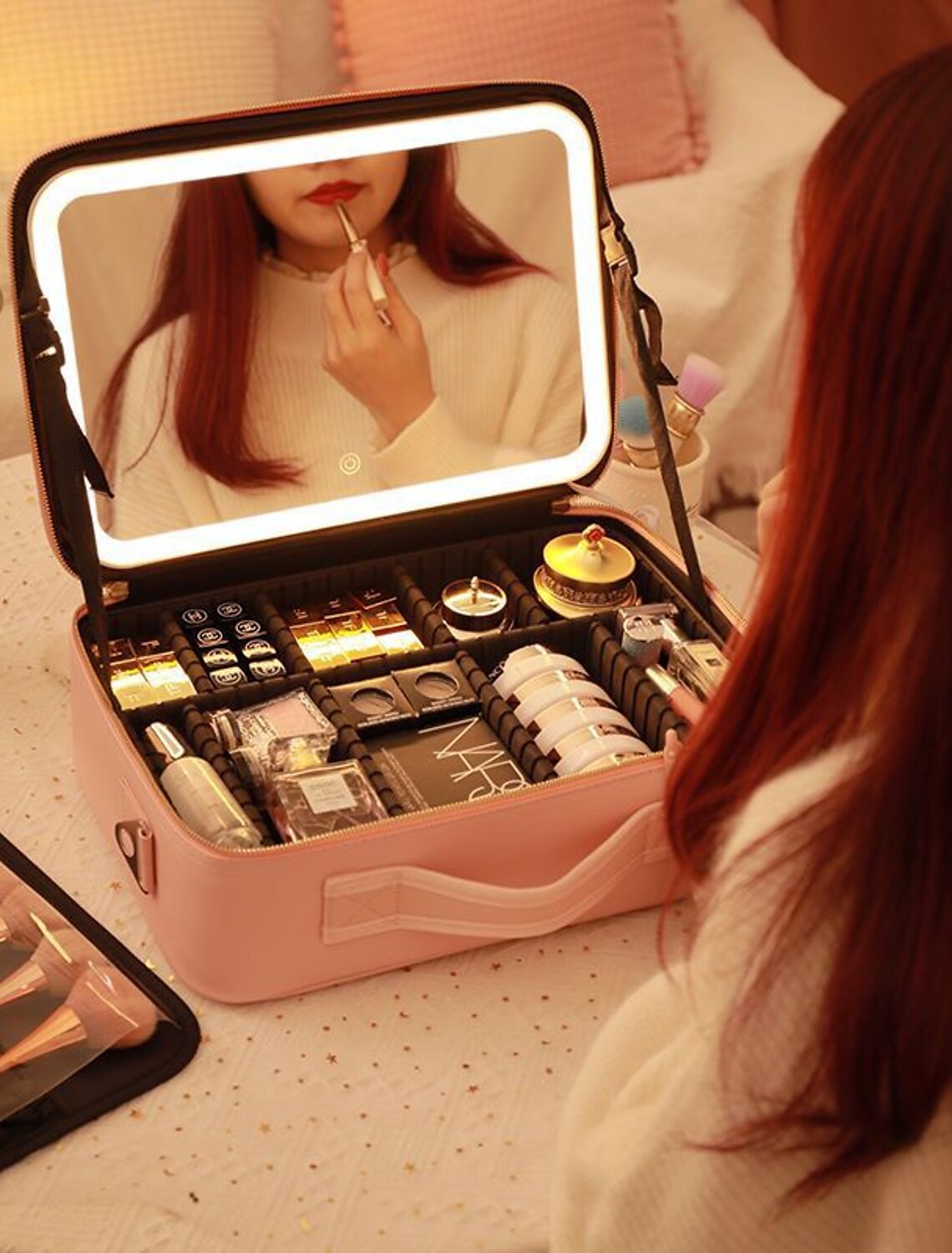 Portable makeup bag being carried, highlighting its compact design.