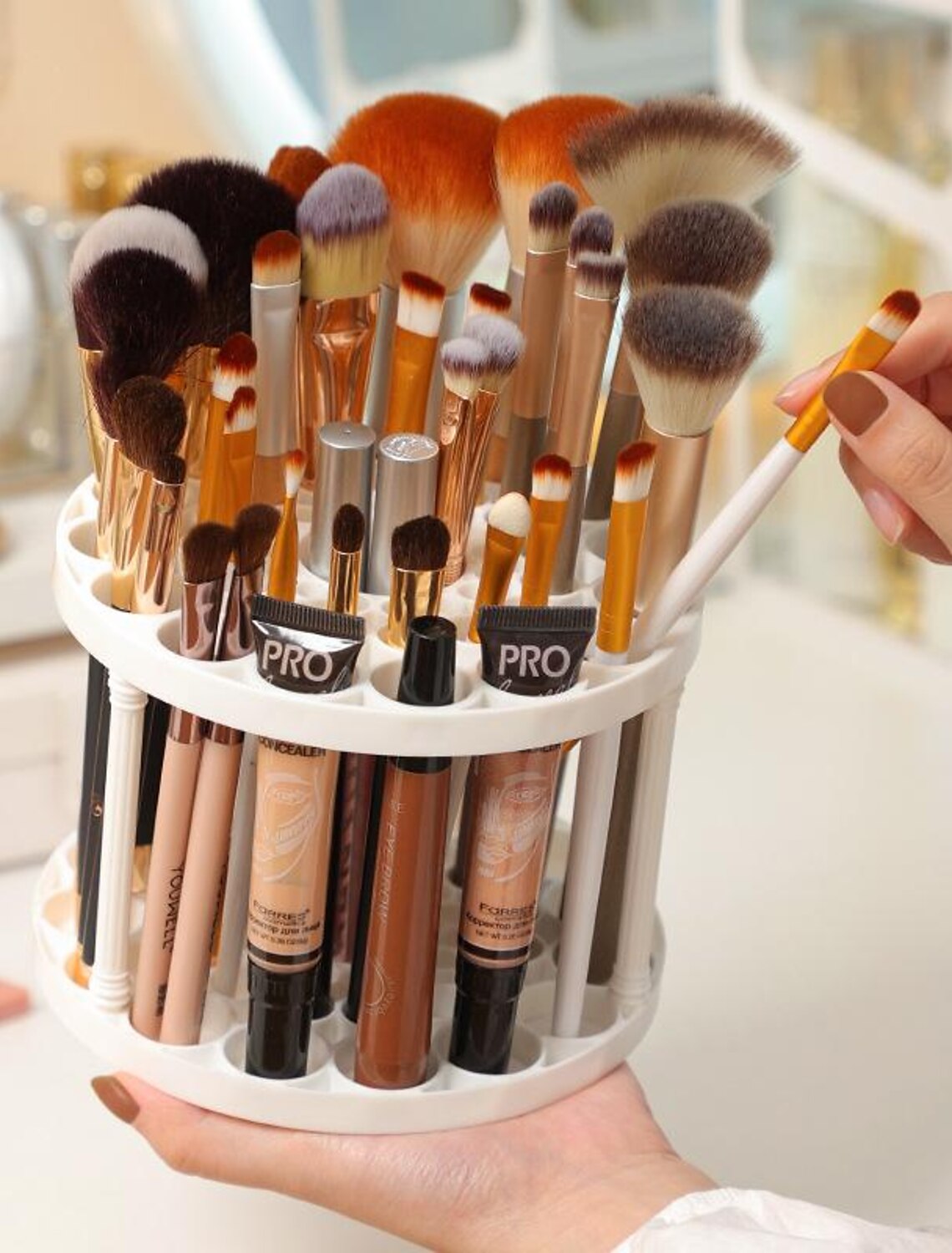 Portable cosmetic brush holder with multiple compartments.