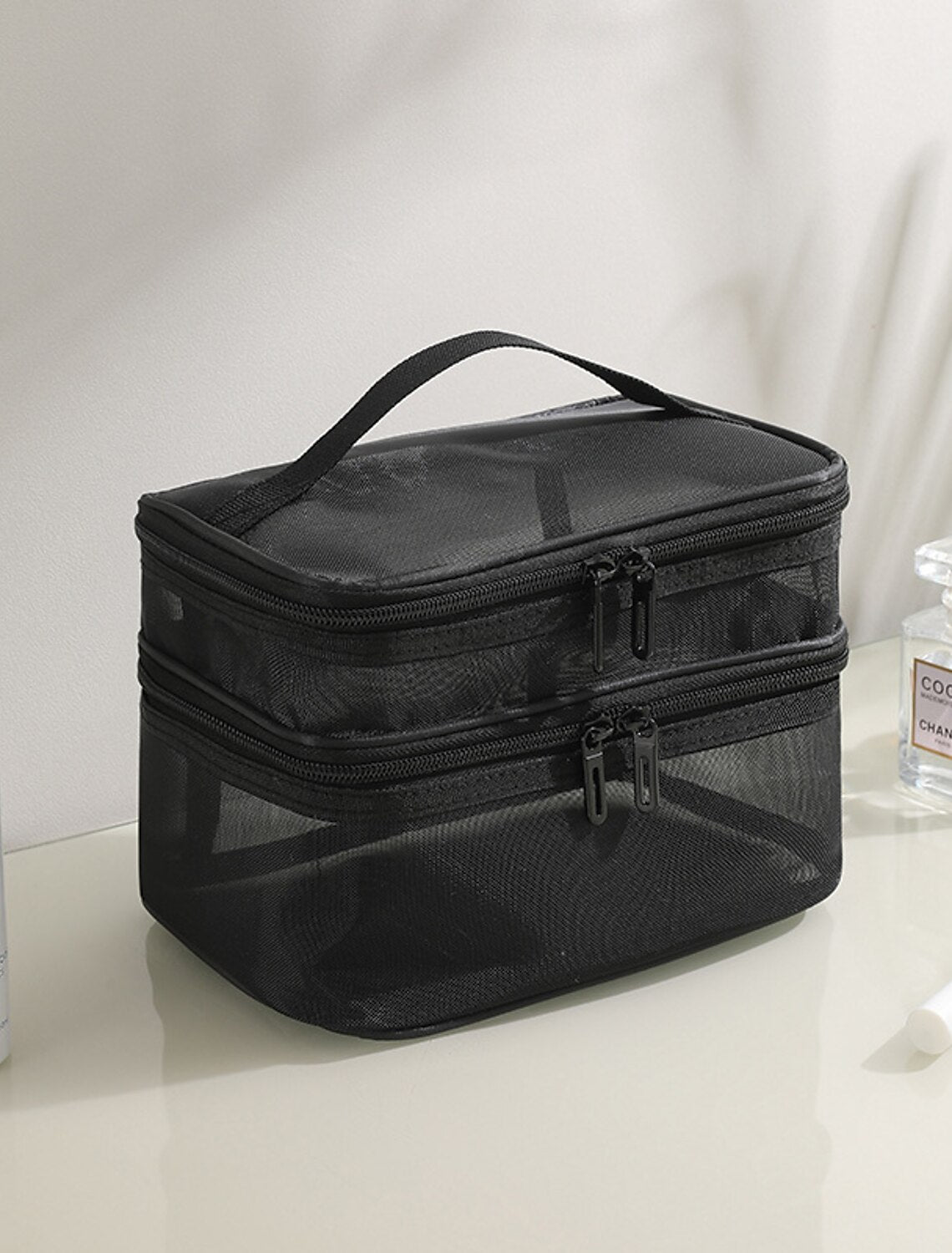 Portable mesh travel makeup bag.