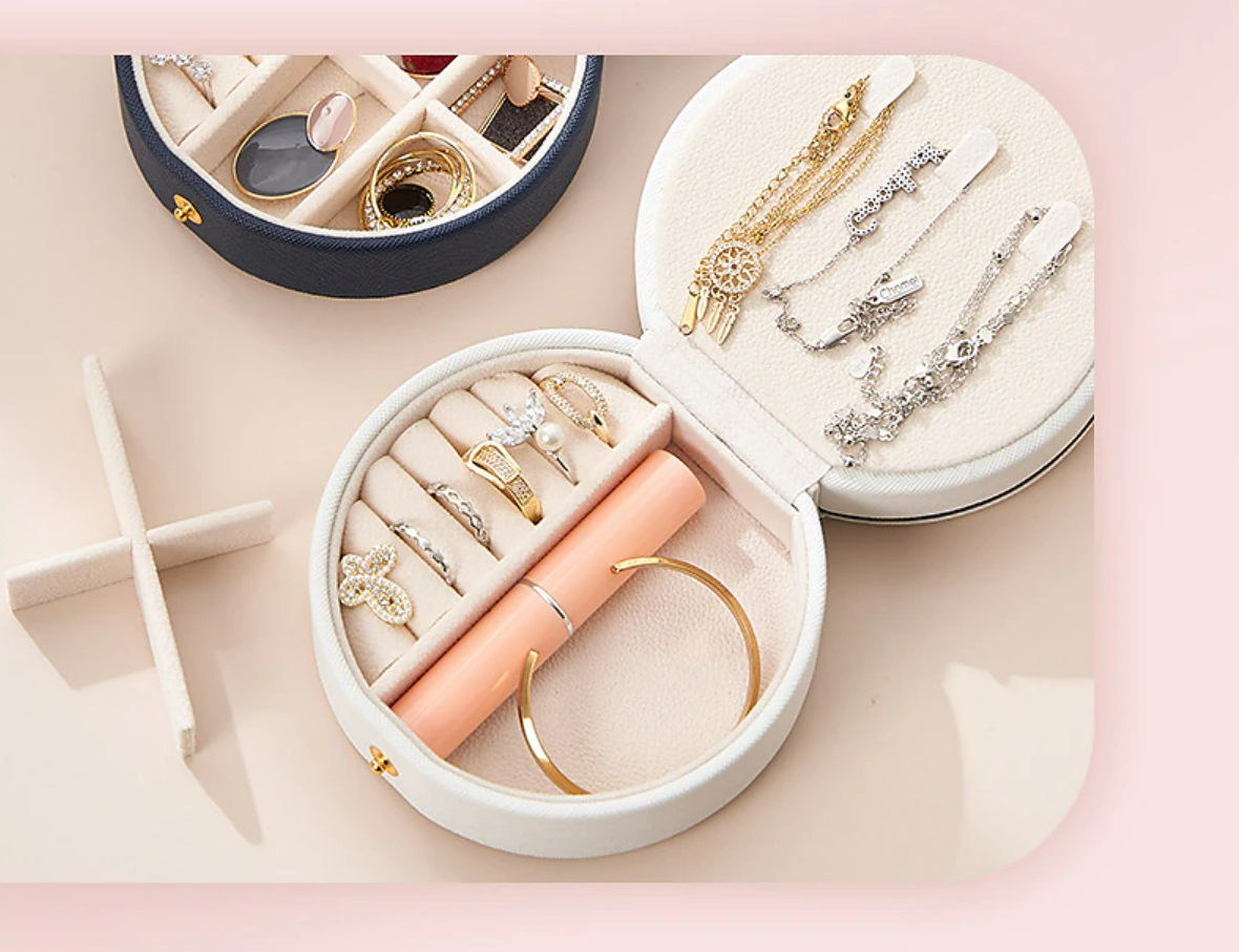 Open mini jewelry case showing ring slots and compartments.