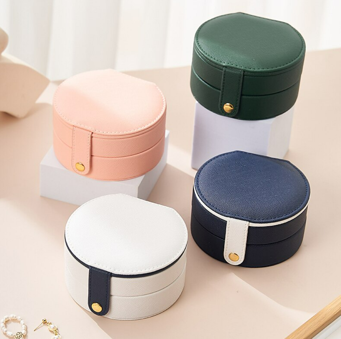 Closed mini travel jewelry case held in hand.