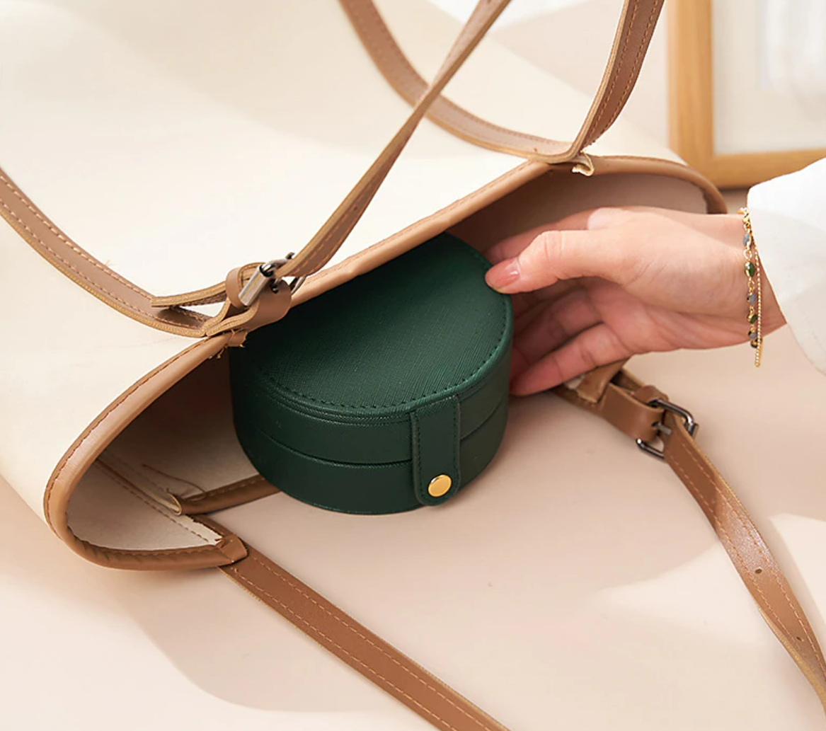 Open jewelry case displaying multiple compartments.
