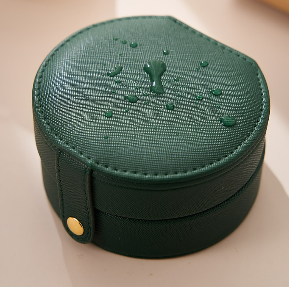 Portable jewelry case, closed, on a surface.