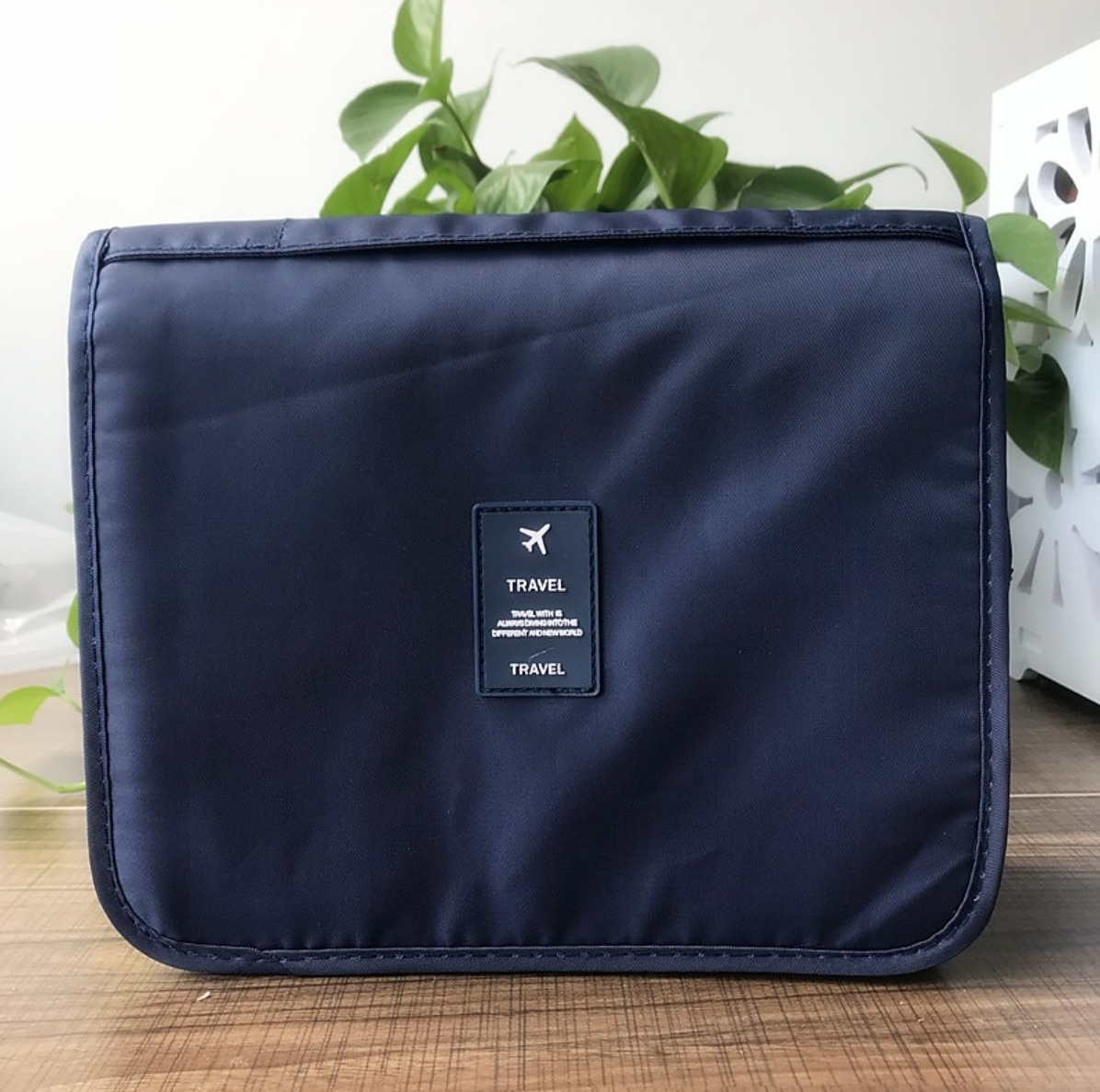 Twill wash bag hanging from a hook, ready for travel.