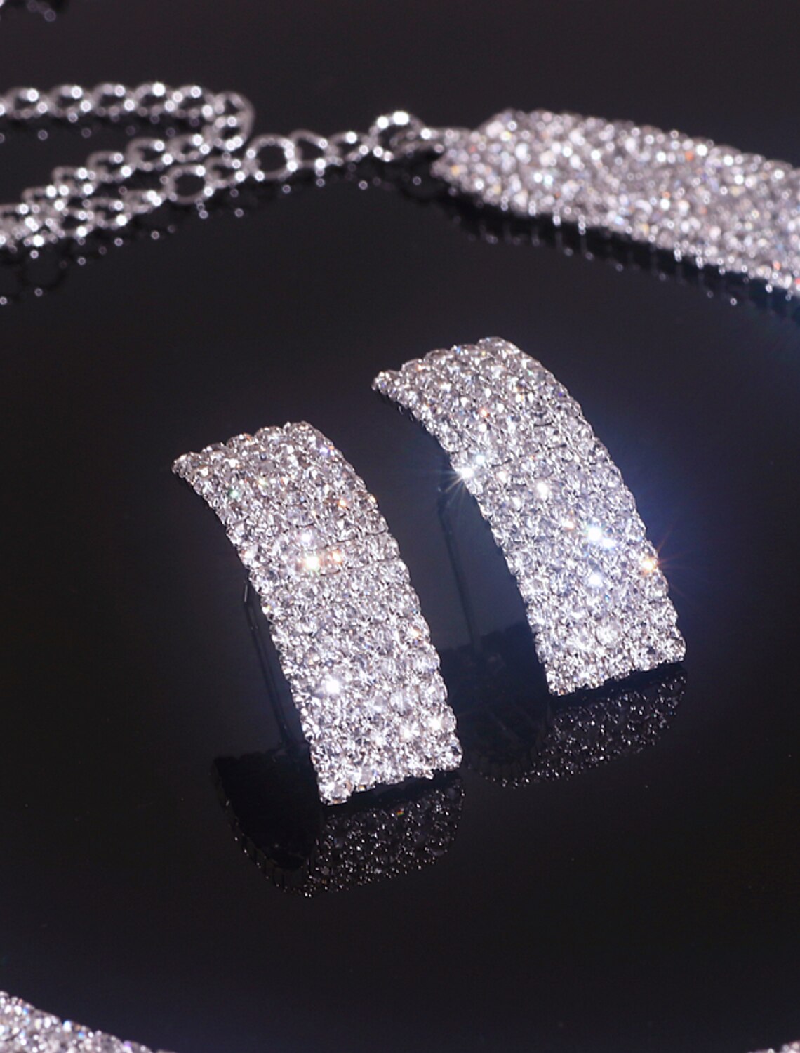 Rhinestone earrings with a classic geometric pattern.