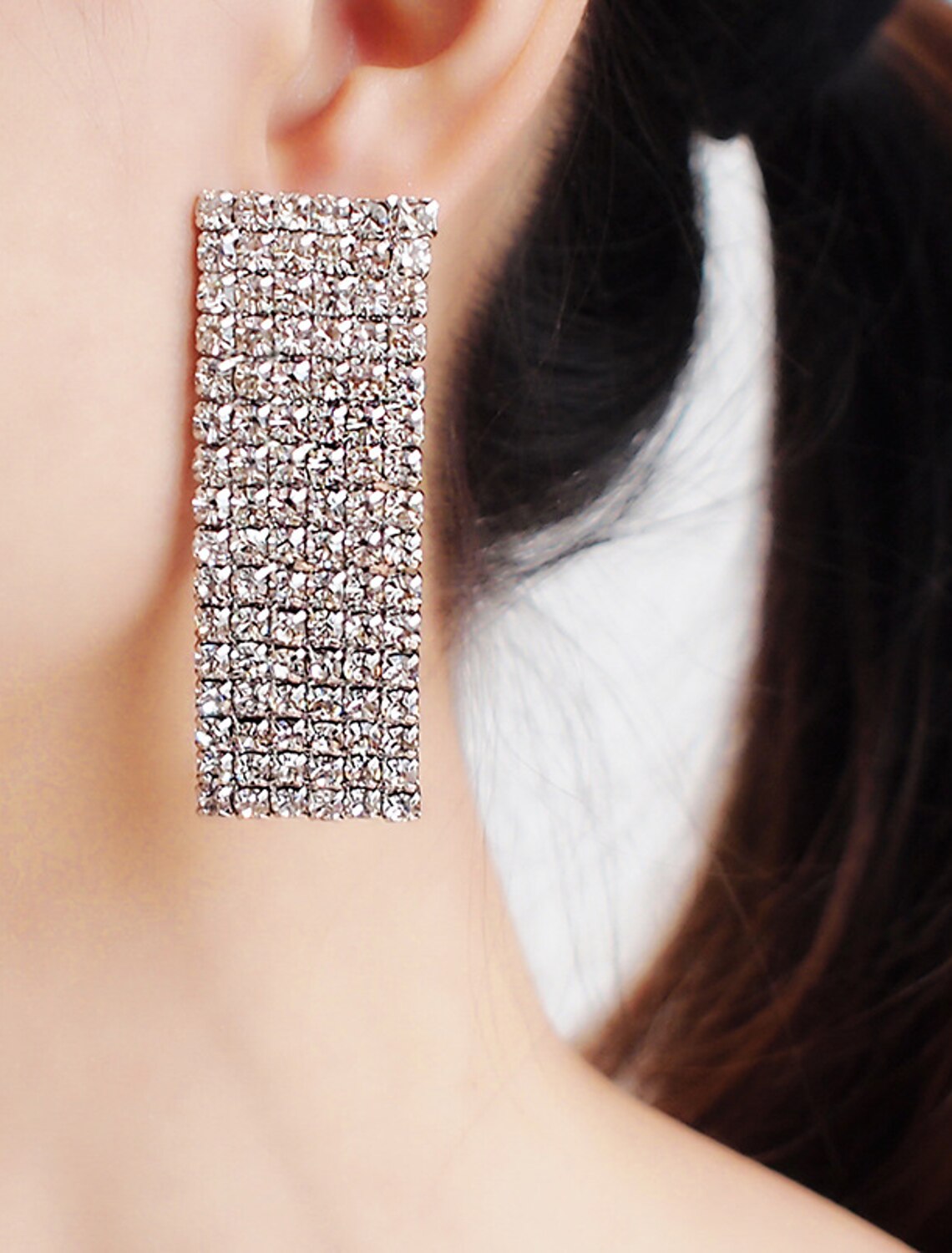 Elegant rhinestone necklace and earring set on display.