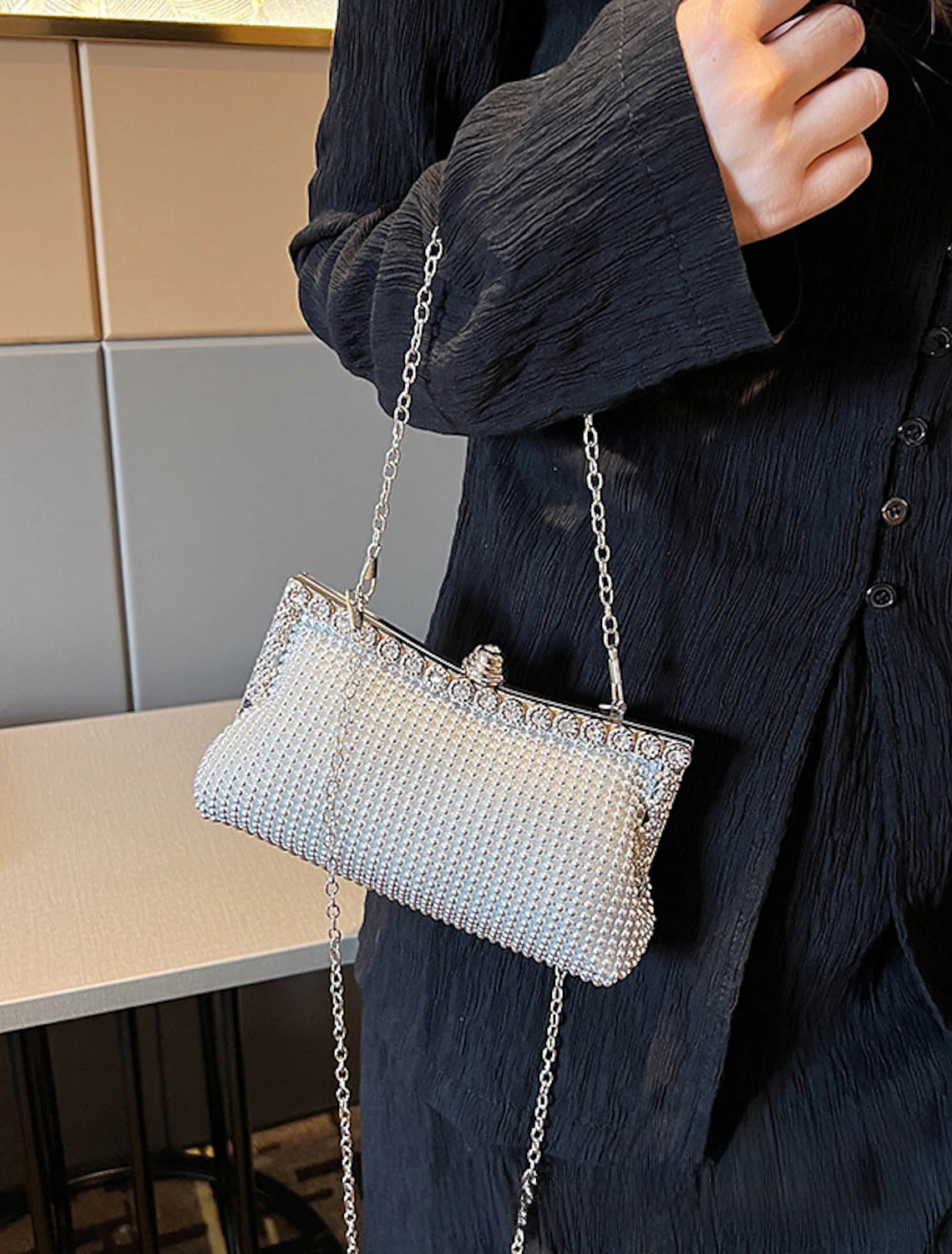 Elegant polyester clutch bag with sparkling rhinestone detail.