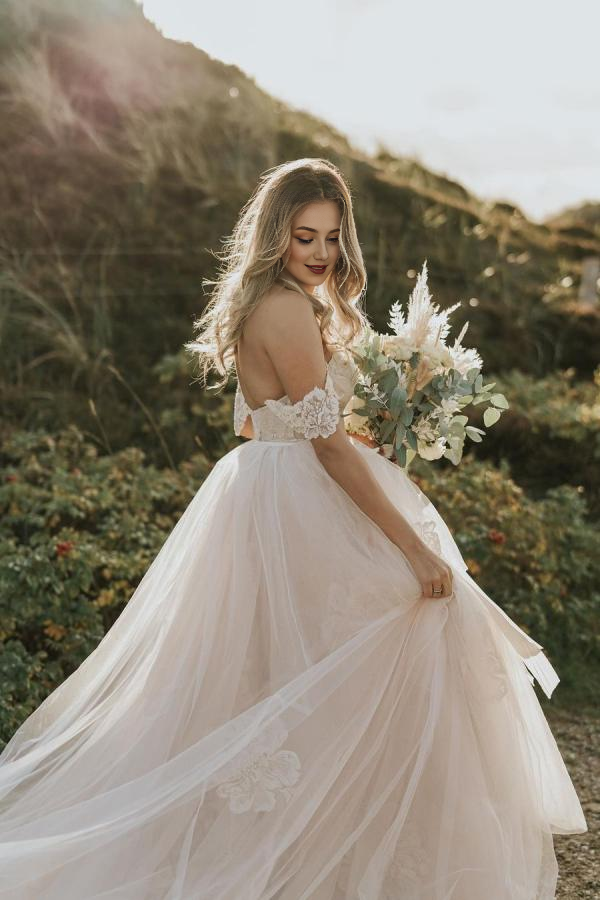 Full view of an A-Line off-shoulder backless lace tulle long wedding dress.