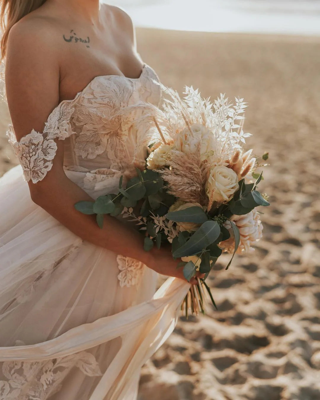 Side view of the flowing A-Line silhouette of the long wedding dress.