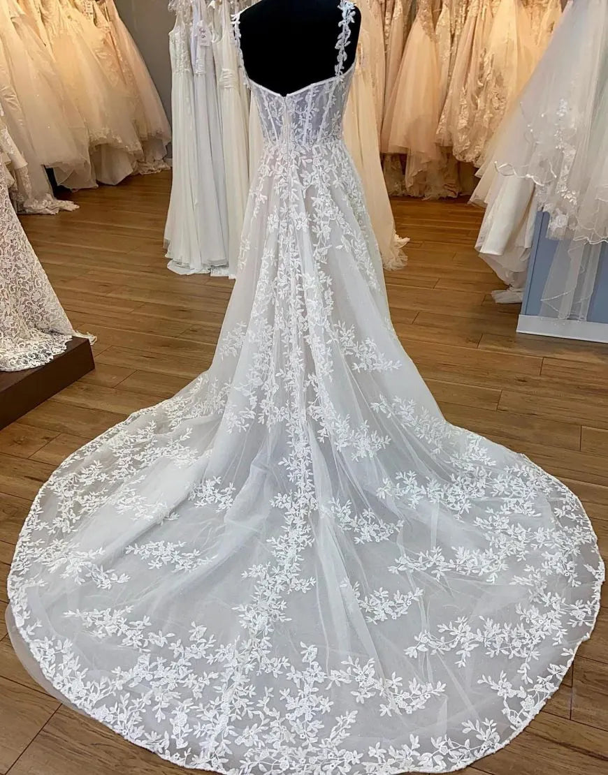 Back view of A-Line wedding dress showing court train and applique details.