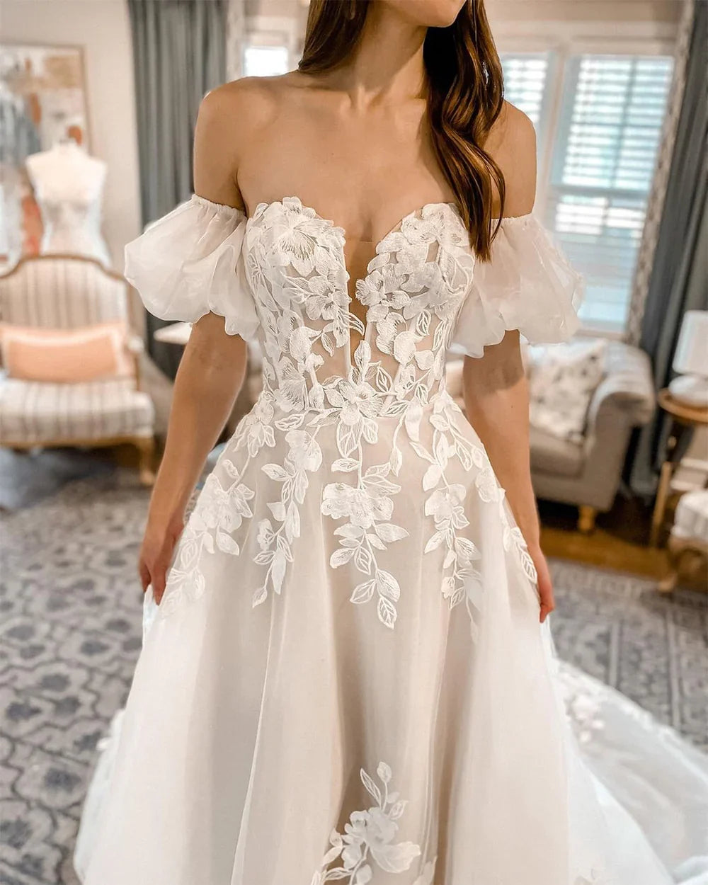 Close-up of intricate lace appliques on the bodice of a bridal gown.