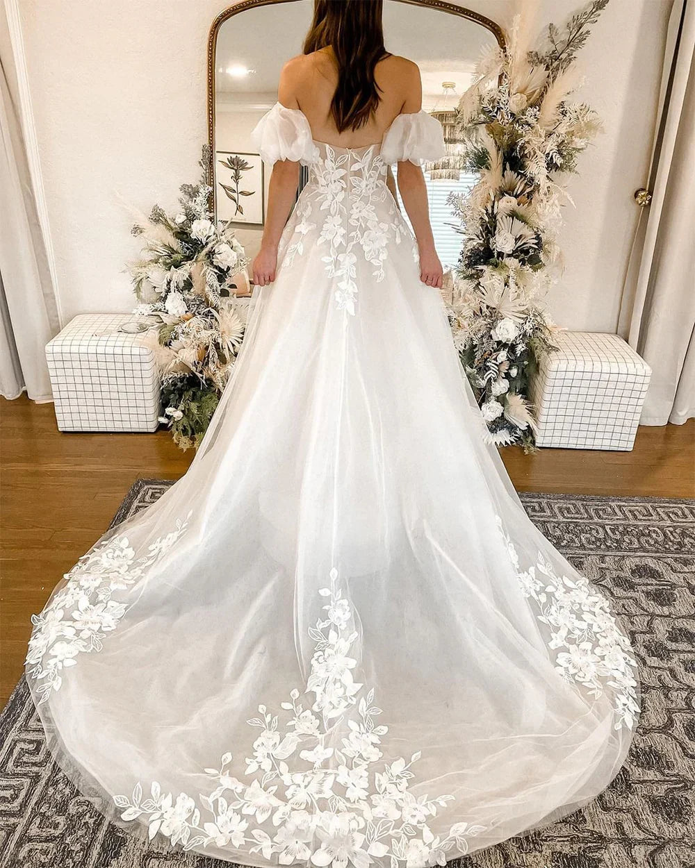 Full back view of a romantic tulle wedding dress with a graceful train.