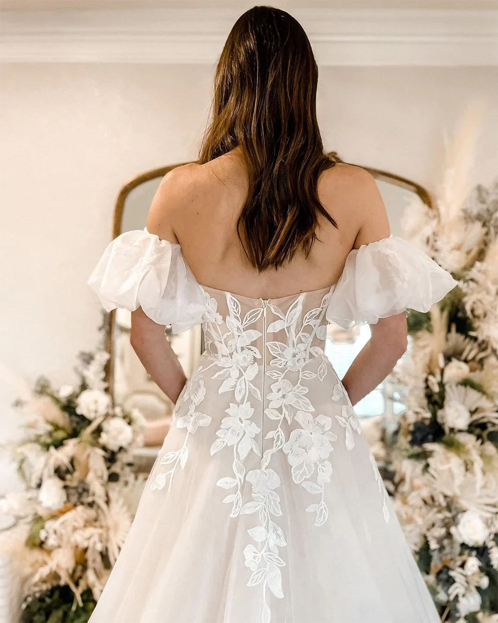 Side profile of a bride wearing a beautiful A-Line lace and tulle wedding dress.