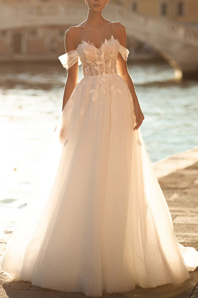 Elegant A-line sweetheart wedding dress with intricate appliques.