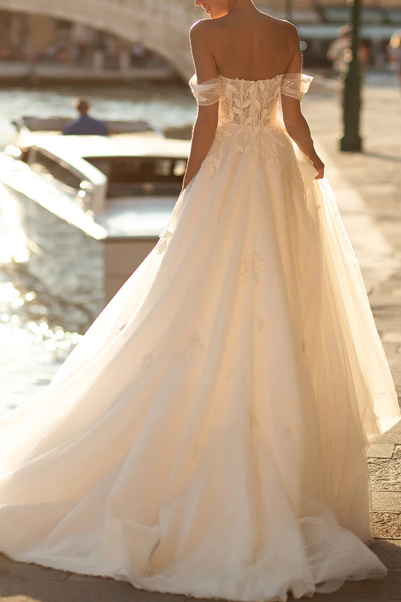 Romantic bridal gown featuring a sweetheart neckline and flowing A-line skirt.