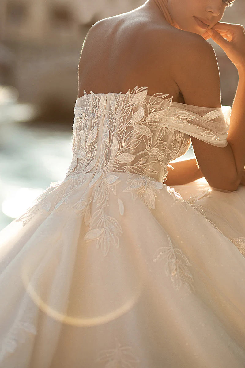 Detail of delicate floral appliques on a wedding dress bodice.