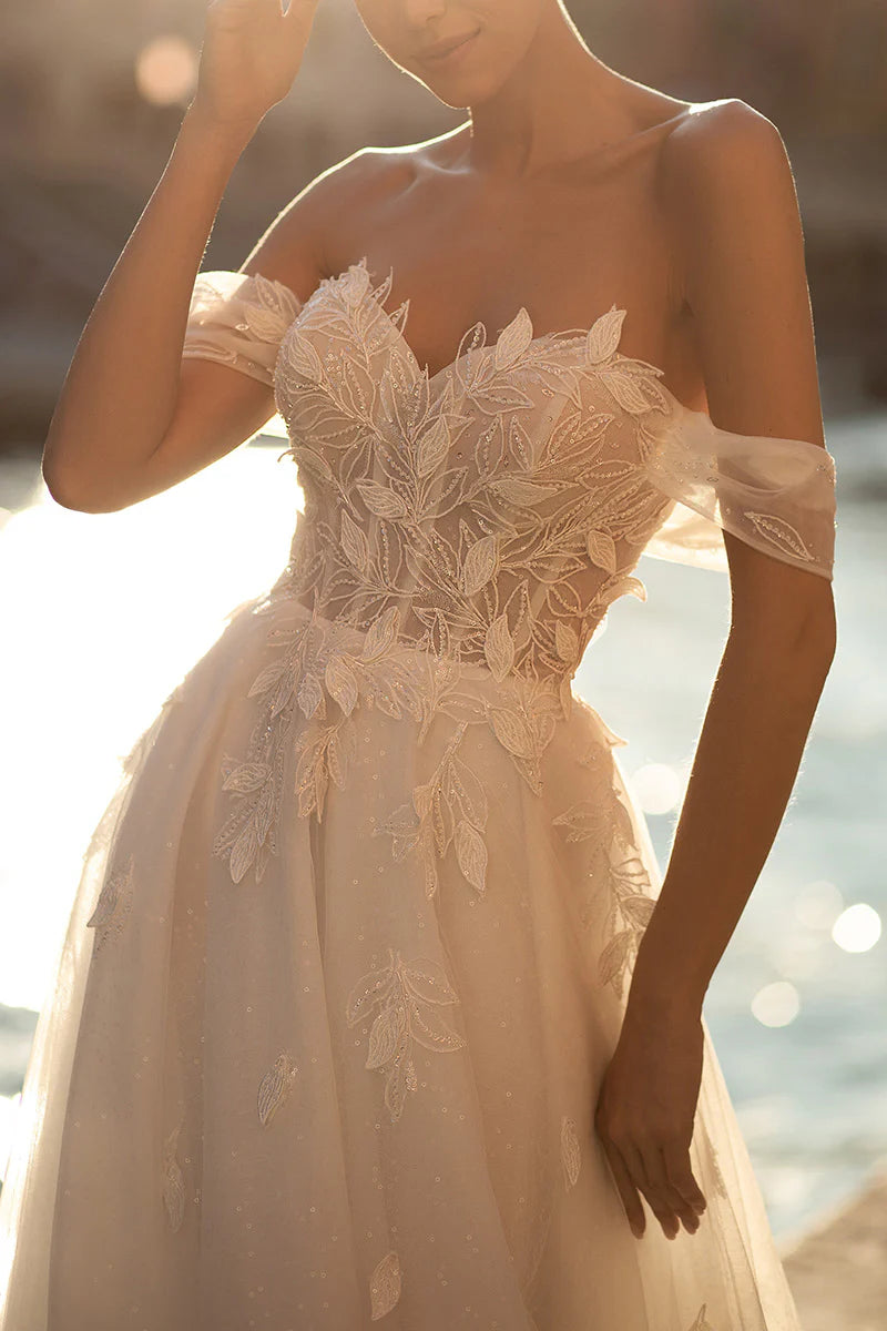 Full length view of a sleeveless A-line wedding dress.