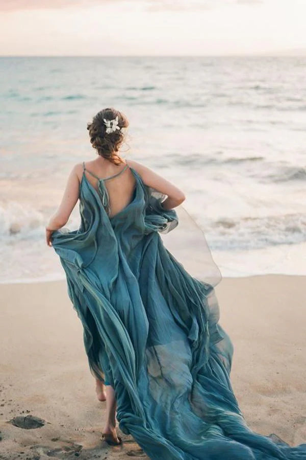 Back view of a rustic chiffon wedding dress with a court train.