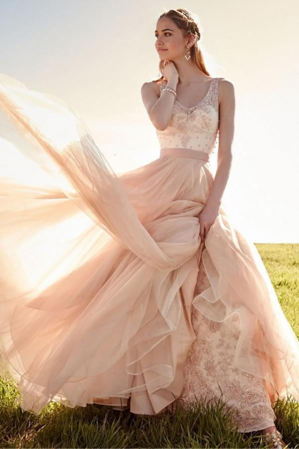 Blush pink A-line wedding dress with V-neck and lace details, featuring a detachable skirt.