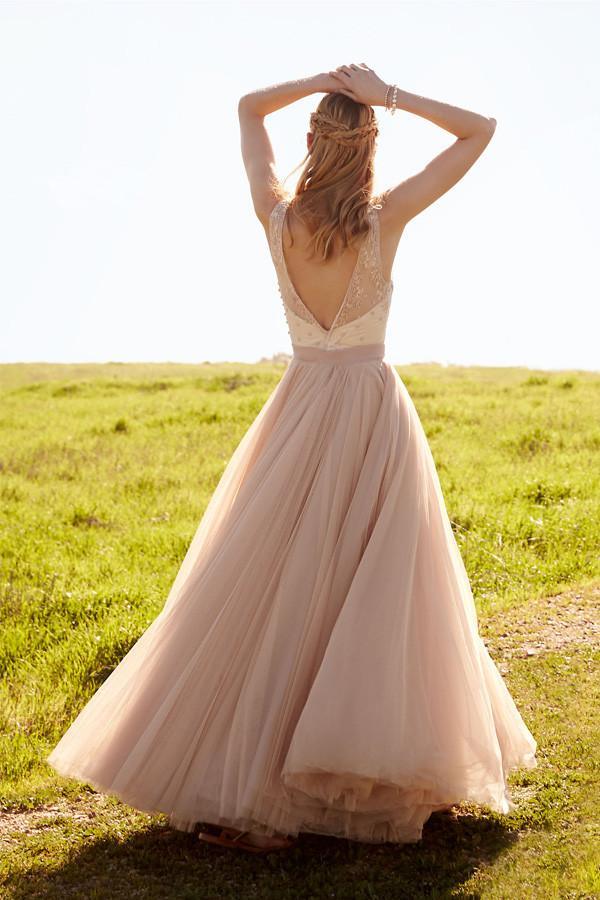 Close-up of the V-neckline and delicate lace on the blush pink bridal gown.
