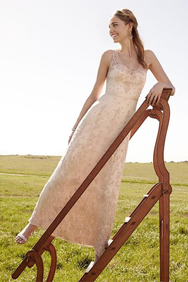 Back view of the romantic blush pink wedding dress, showcasing the flowing A-line skirt.