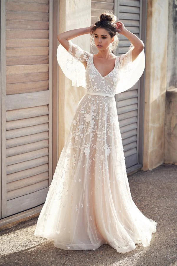 Romantic A-line wedding dress with lace and flower appliques.
