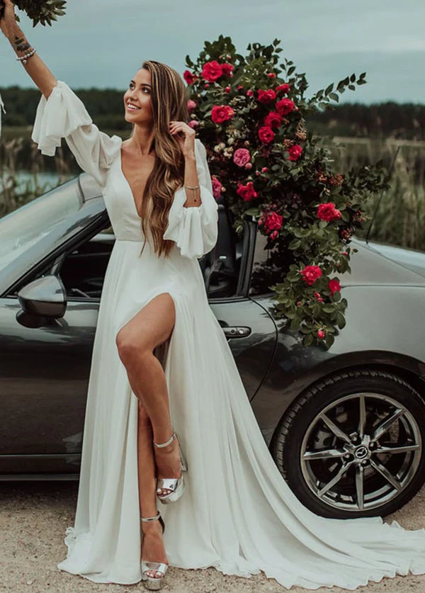 Front view of a romantic A-line V-neck long-sleeve chiffon wedding dress with a high slit.