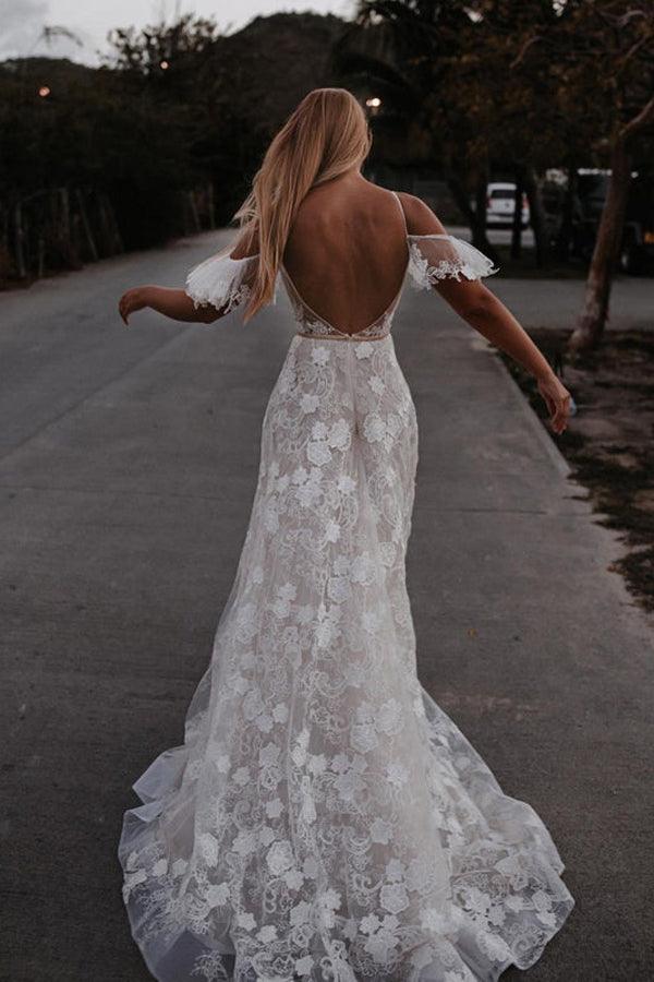 Side profile of a bride in the V-neck floral lace wedding gown.