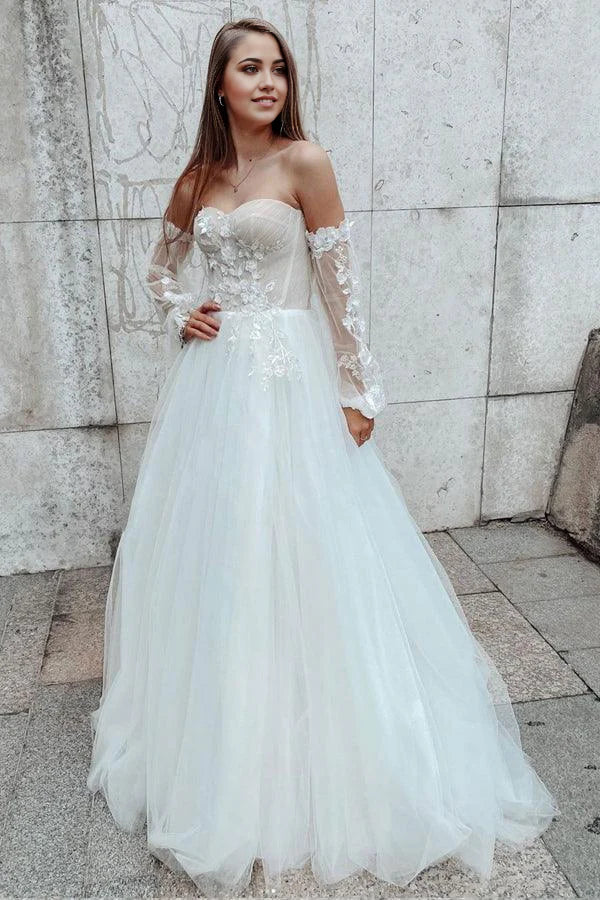 Elegant A-line sweetheart lace wedding gown with detachable sleeves.